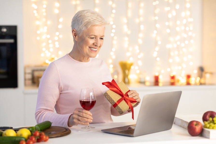 Senior lady using a laptop to do online home styling courses