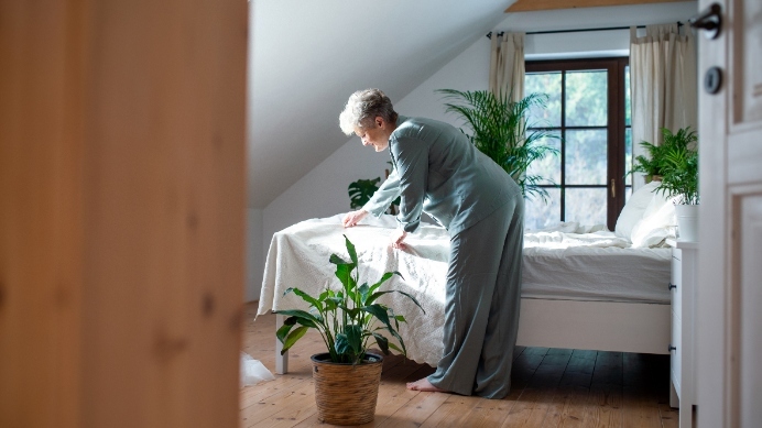 senior-woman-at-home-making-her-bed