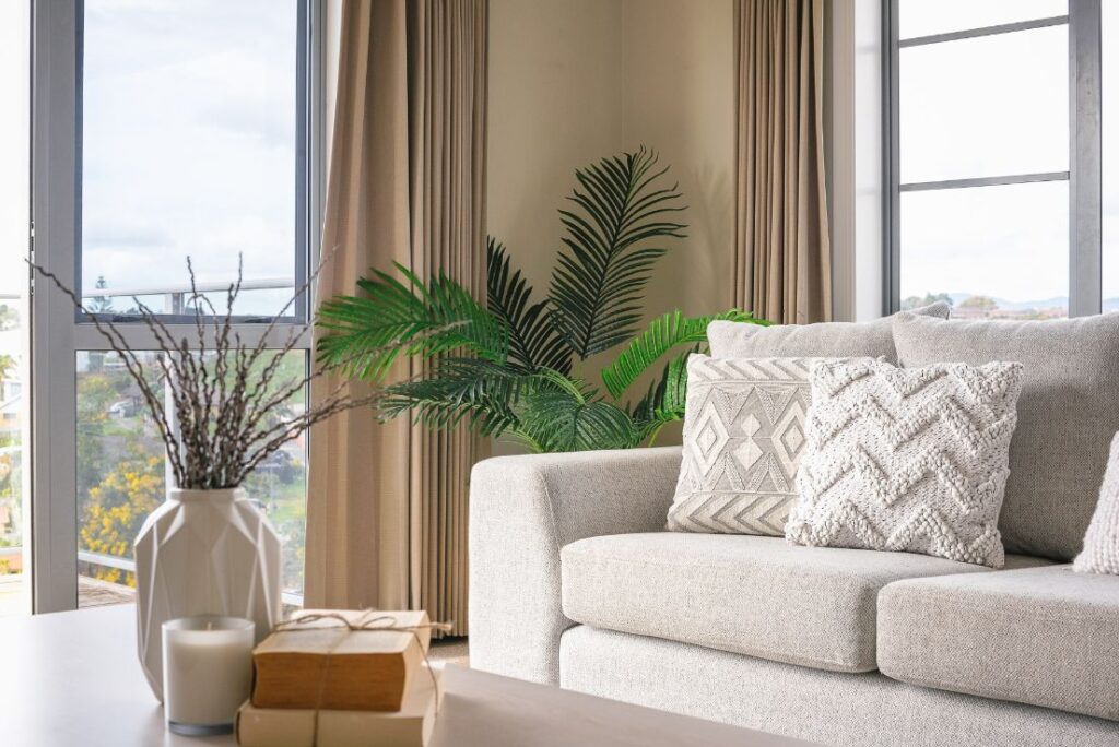 sofa styled with white and beige decorative cushions